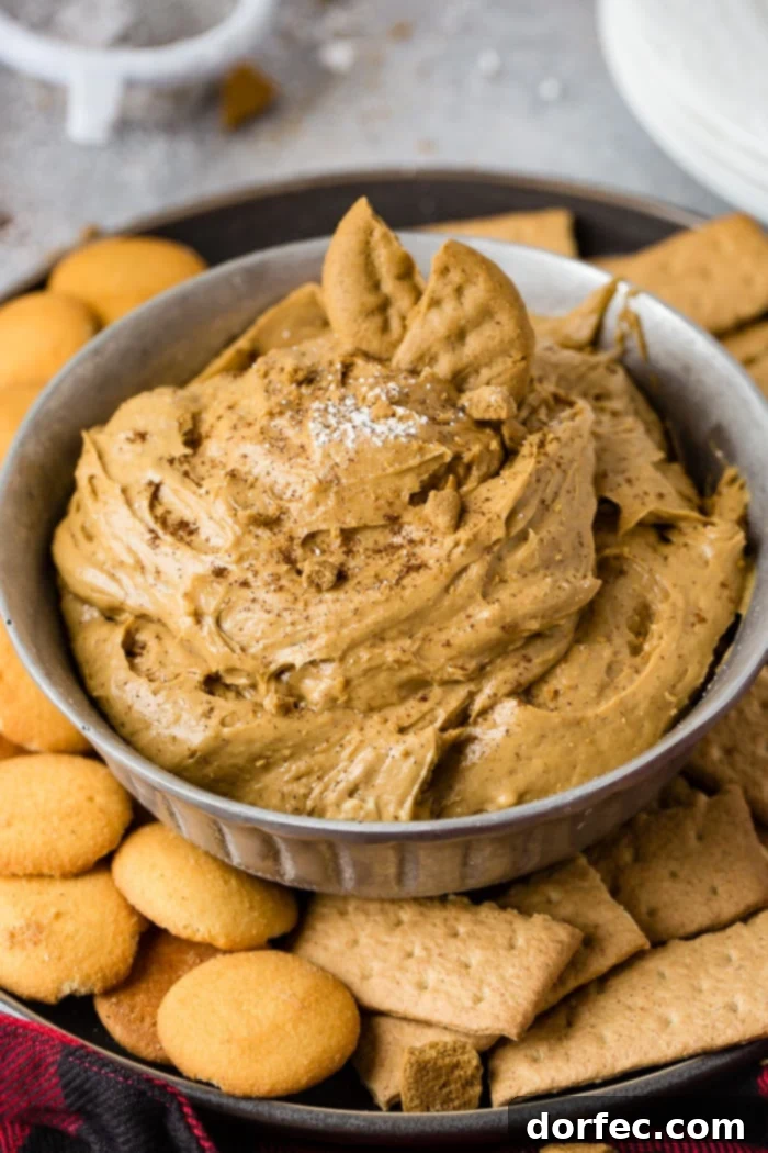Festive Gingerbread Cookie Dip 3 a silver bowl full of fluffy gingerbread cookie dip or molasses cookie dip with graham crackers and nilla wafers