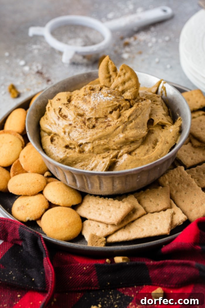 Festive Gingerbread Cookie Dip 6 a silver bowl full of fluffy gingerbread cookie dip or molasses cookie dip with graham crackers and nilla wafers