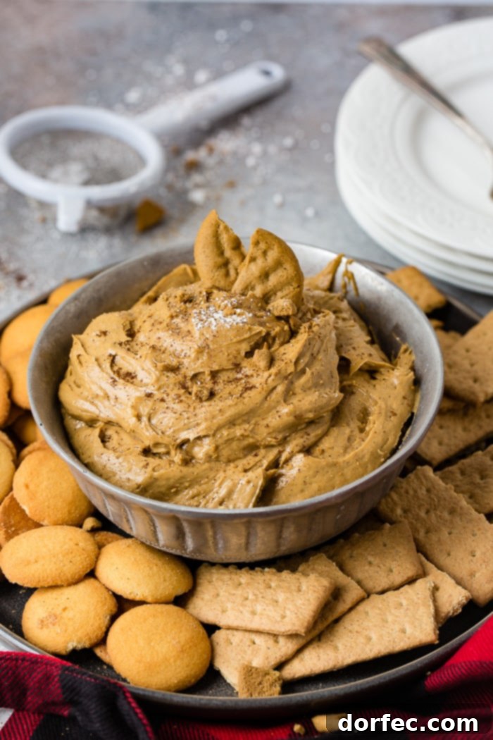 Festive Gingerbread Cookie Dip 7 a silver bowl full of fluffy gingerbread cookie dip or molasses cookie dip with graham crackers and nilla wafers
