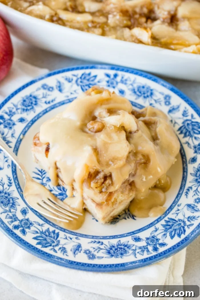 Irresistible Apple Pie Bread Pudding with Silky Vanilla Sauce 8 A full, vibrant slice of apple pie bread pudding, beautifully plated with vanilla sauce, a perfect treat.