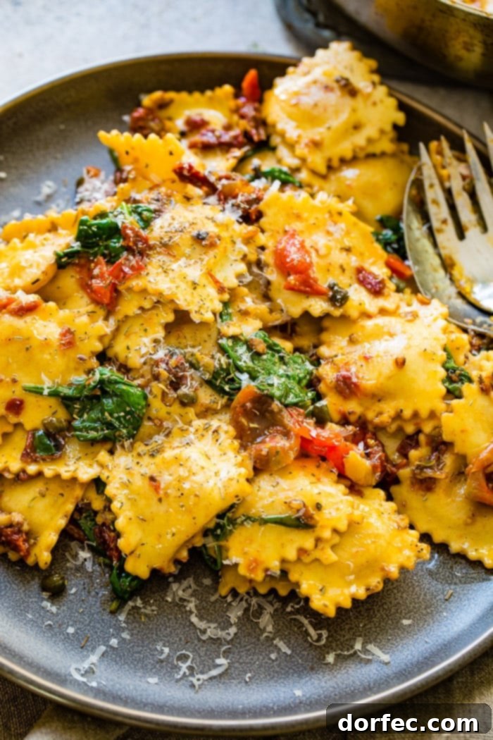 Freshly cooked ravioli being tossed in a skillet with crispy pancetta, sun-dried tomatoes, and spinach.
