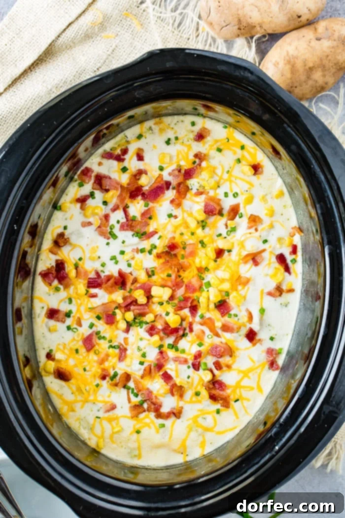 A bowl of slow cooker potato broccoli corn chowder with bacon, presented on a rustic wooden surface with a spoon.
