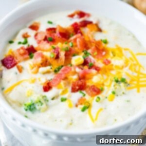 A bowl of slow cooker potato broccoli corn chowder with bacon, garnished with chives.