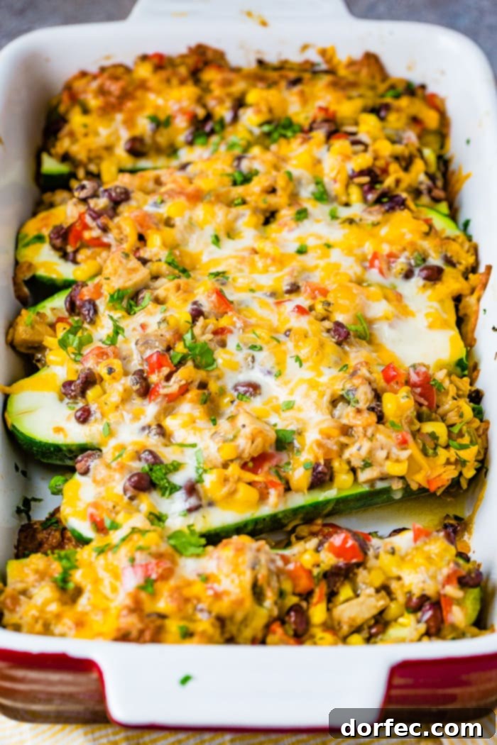 A wide shot of Cheesy Healthy Mexican Zucchini Boats, showcasing the entire casserole dish, highlighting the rustic presentation and the inviting blend of colors and textures.