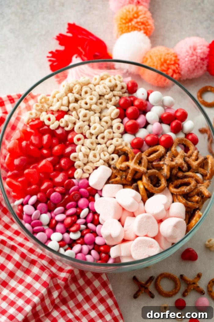 A large glass bowl filled with the festive Valentine's Snack Mix, ready to be enjoyed or packaged for gifting.