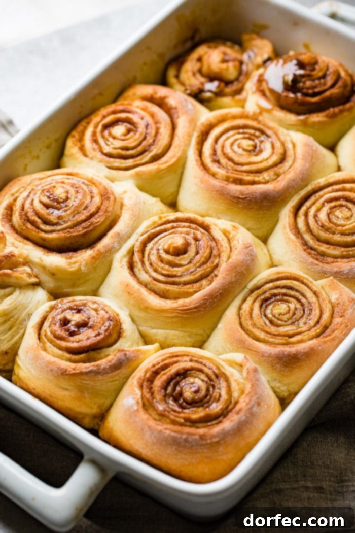 Caramel Pecan Sticky Buns 3 A ohoto of a dozen sweet rolls still sitting in the baking dish so the gooey caramel side is face down.