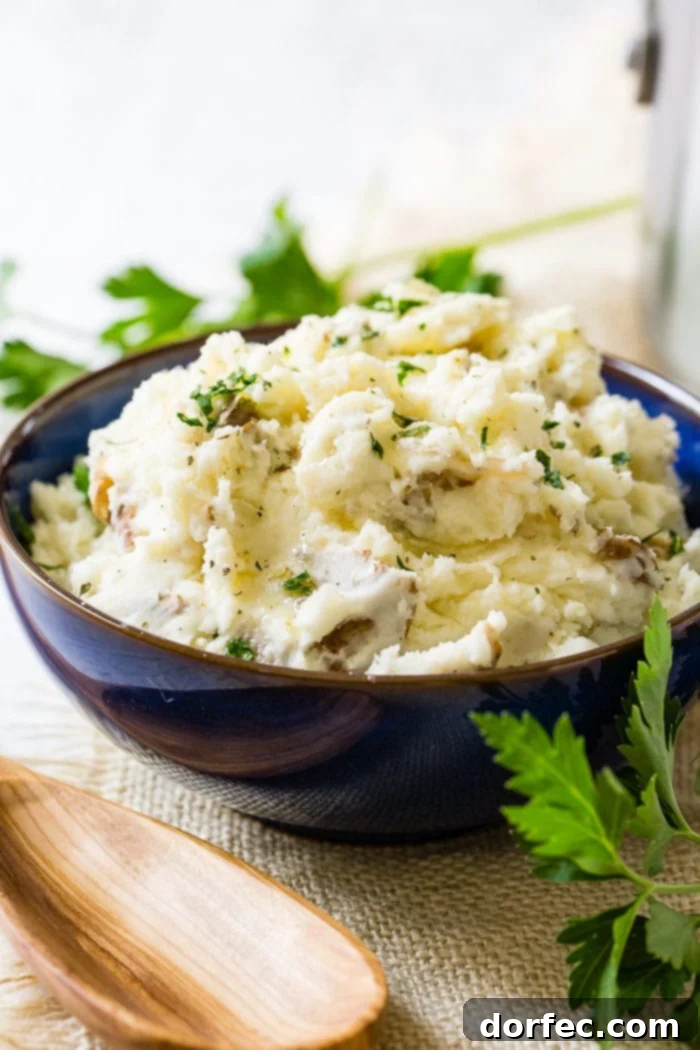 Crispy Smashed Steakhouse Potatoes 4 A serving bowl filled with a generous portion of chunky smashed potatoes, accented with fresh chopped parsley.