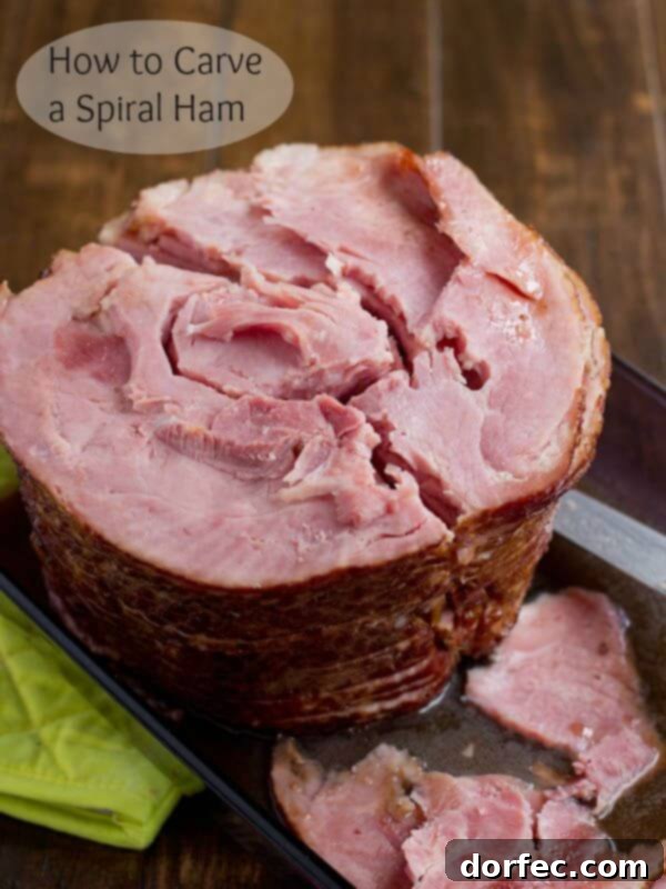 A close-up view of a spiral-cut ham on a cutting board with the bone neatly removed, showcasing perfectly separated slices ready for serving.
