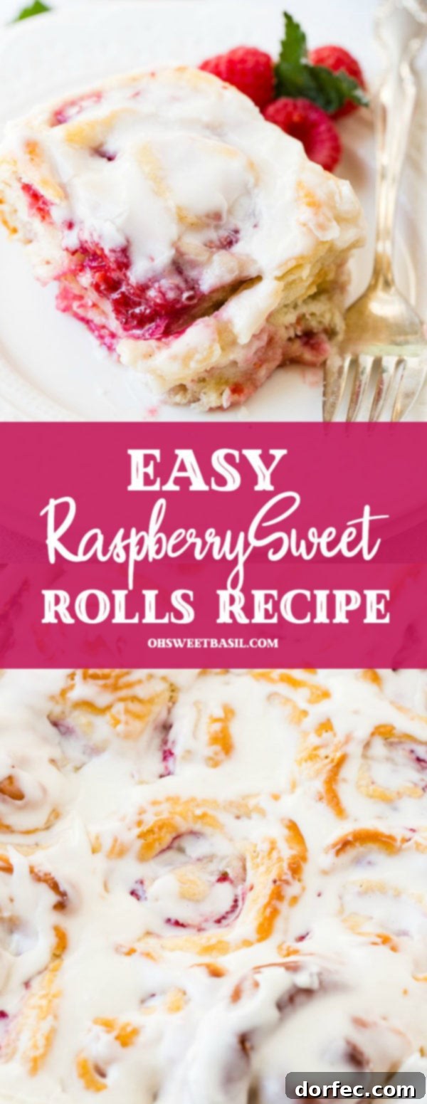 A frosted easy berry sweet roll on a white plate with a fork laying beside it and fresh raspberries next to it.