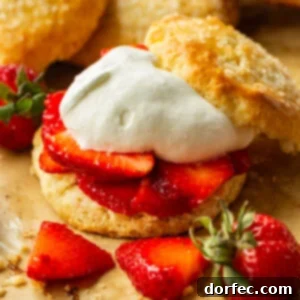 A photo of a golden sweet biscuit filled with juicy strawberry slices and fluffy whipped cream