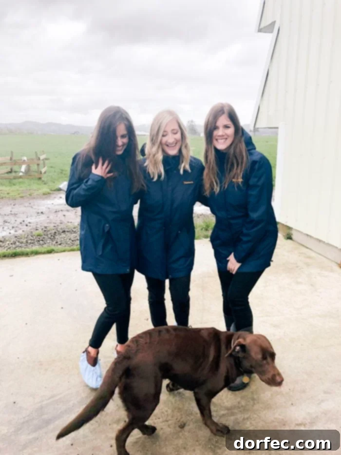 Road Trip Ready Smart Snacks and Fun Printables 11 Three friends smiling and posing for a photo at Tillamook Farms in Tillamook, Oregon, capturing a moment of shared enjoyment during their visit to the dairy farm.