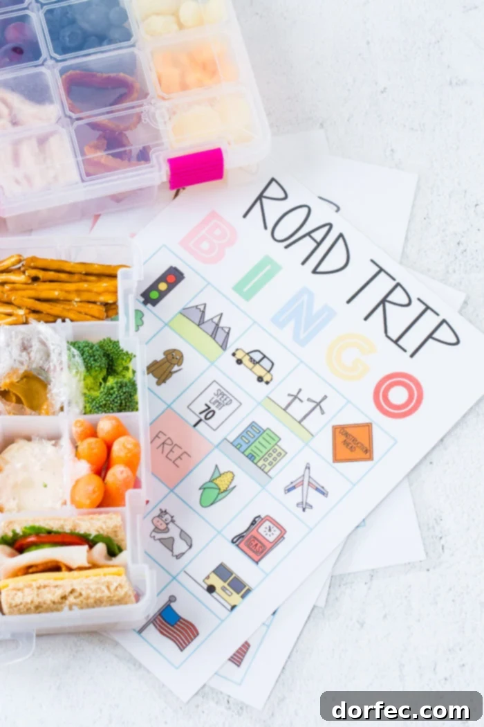 Road Trip Ready Smart Snacks and Fun Printables 5 A vibrant, neatly organized craft box filled with an array of nourishing snacks for a road trip, displayed alongside a free printable for Road Trip Bingo. The box contains fruits, nuts, cheese, and crackers, emphasizing healthy and fun travel solutions.
