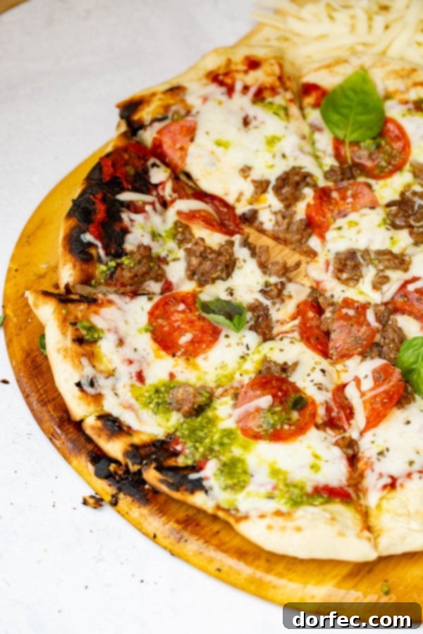 A photo of a pesto pepperoni grilled pizza.