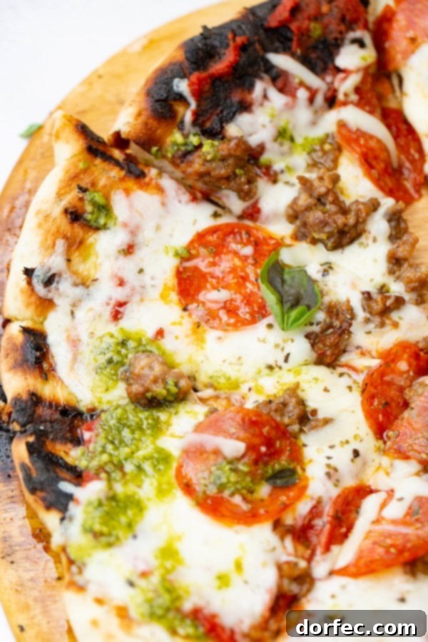 A photo of a pesto pepperoni grilled pizza.