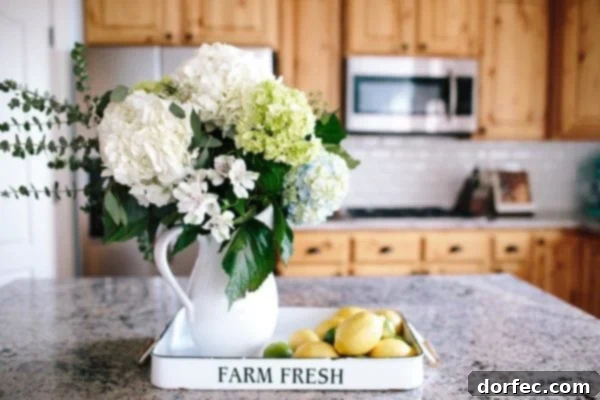 A photo of a vase of flowers and pile of lemons in a tray on the island in our kitchen.
