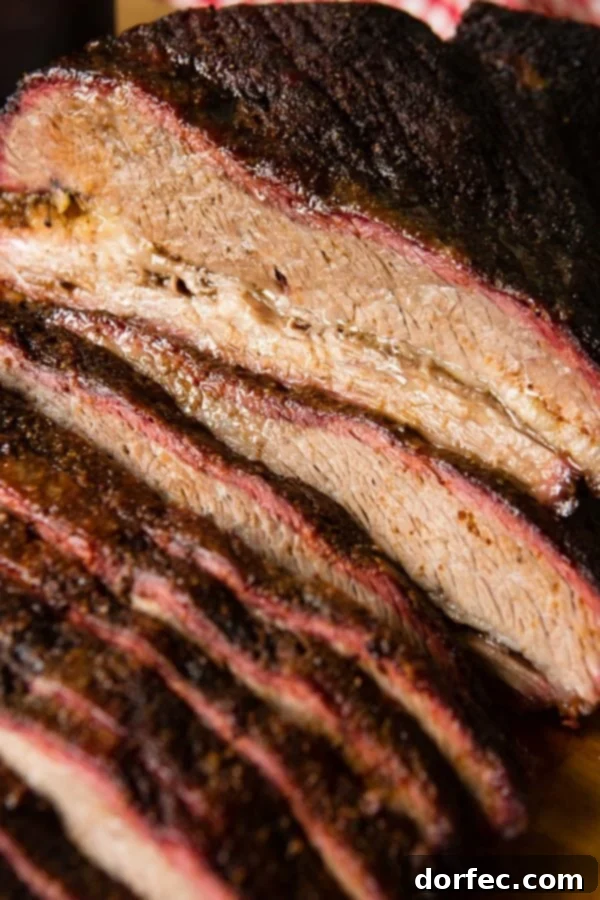 A photo of perfectly smoked brisket sliced with a beautiful smoke ring.