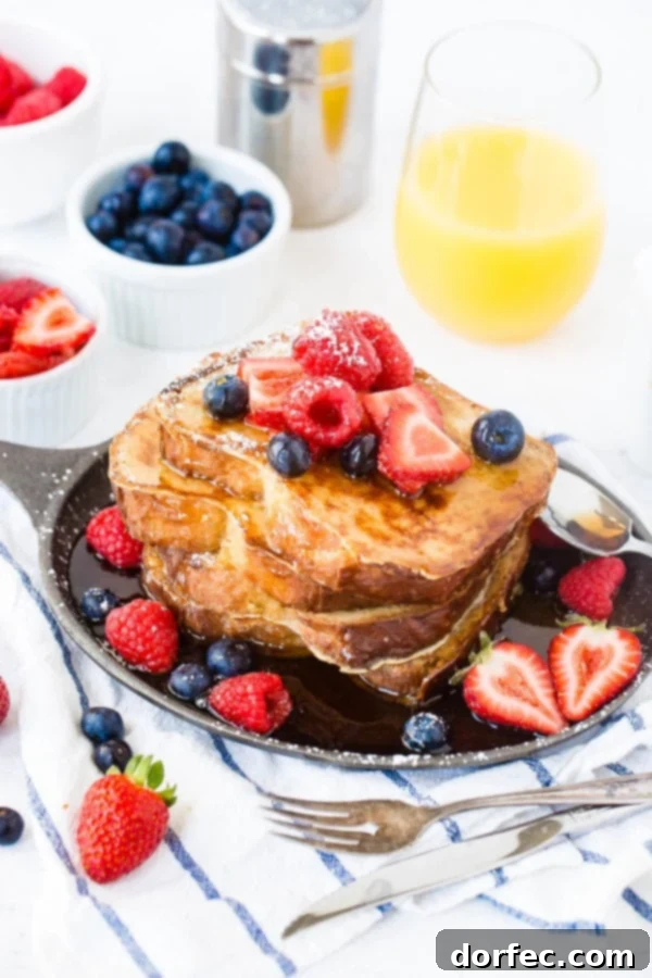 Perfectly Made French Toast A photo of a stack of golden-brown French toast covered in dripping syrup and fresh berries, ready to be enjoyed.