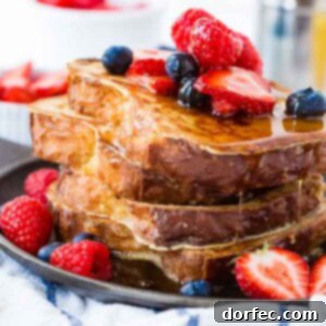 The Secret to Perfect French Toast 2 a stack of french toast with maple syrup and berries on top