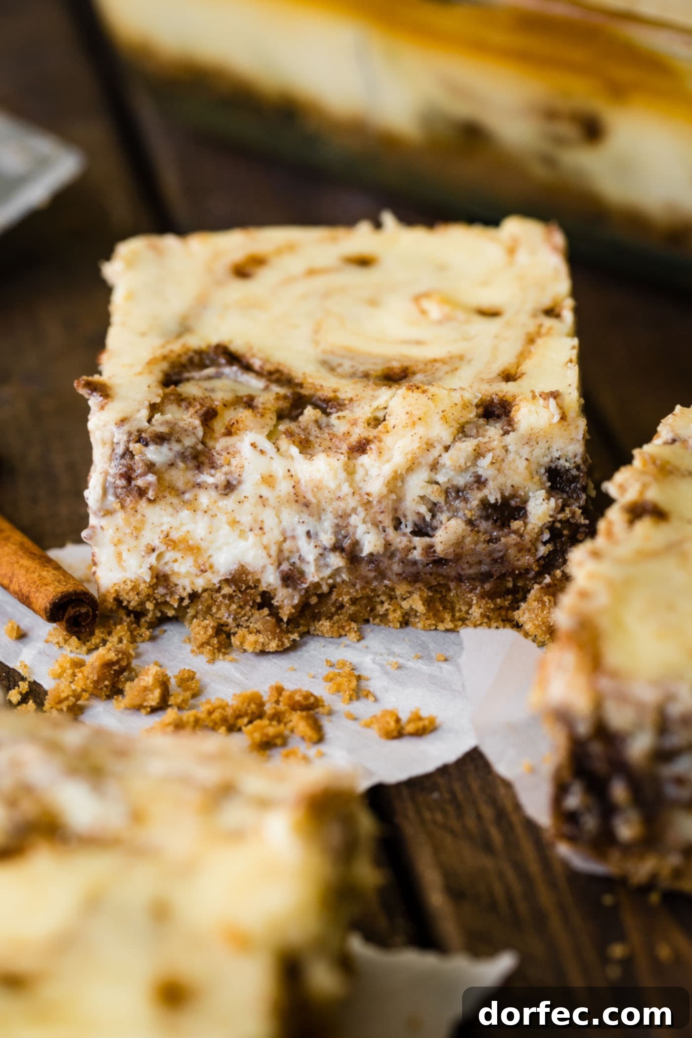 A single cinnamon roll cheesecake bar, beautifully plated and ready for enjoyment.
