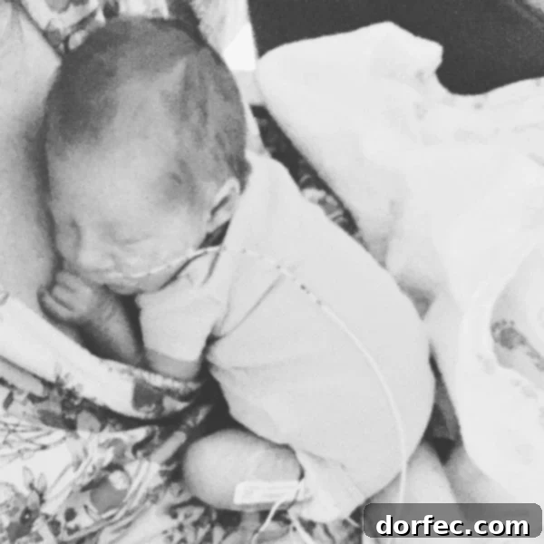 A heartwarming photo of our new little baby boy curled up securely on my chest, a moment of profound connection.