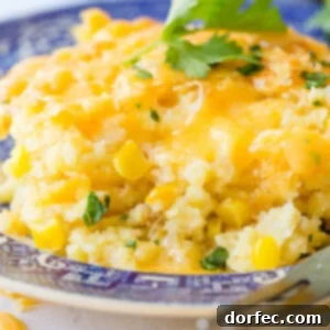 A close-up of a beautifully baked cheesy Jiffy corn casserole, golden and bubbly.