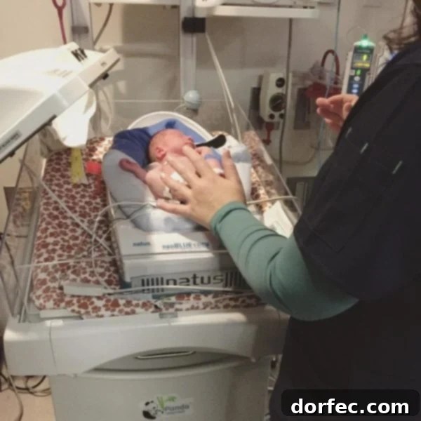Unyielding Faith Through Shadow 3 Our son peacefully sleeping in his tiny NICU bed, a caring nurse gently touching his feet, symbolizing comfort and constant vigilance.