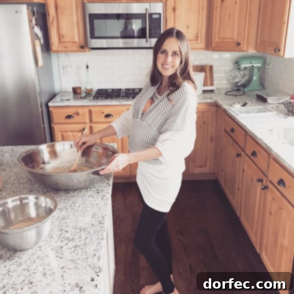 A photo of my cooking in the kitchen with our baby in a wrap on me, depicting the start of a new chapter.