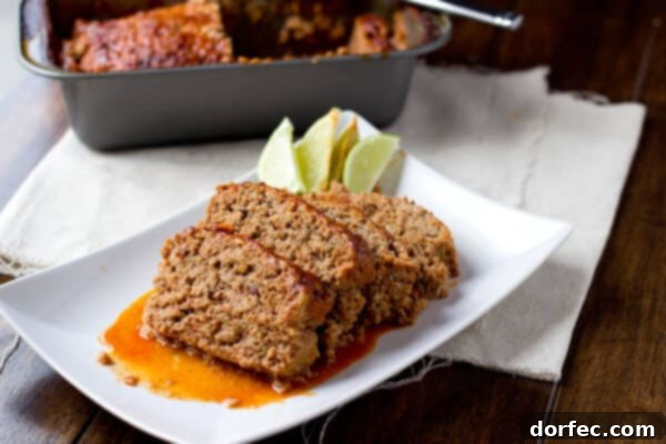 The Grand Finale: Turkey Enchilada Meatloaf with Sauce A perfectly baked Turkey Enchilada Meatloaf, smothered in rich enchilada sauce, ready to serve.