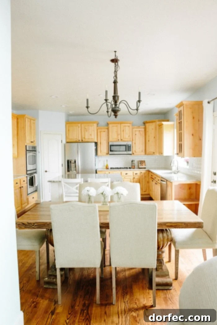 Before photo of an old kitchen with blue walls and dark cabinets, showing its potential for an all-white remodel
