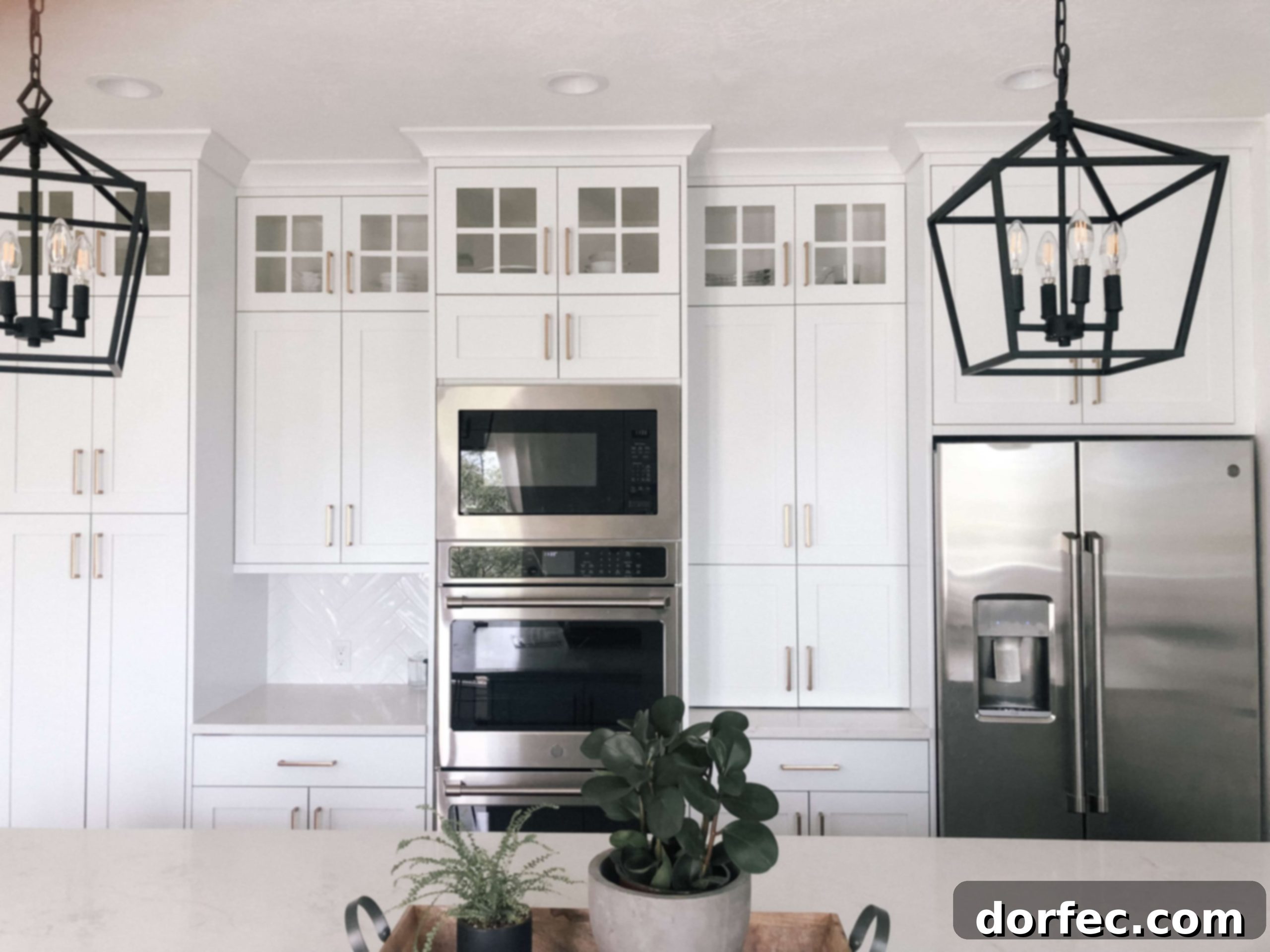 Wide view of the all-white kitchen, emphasizing the seamless integration of appliances and design elements