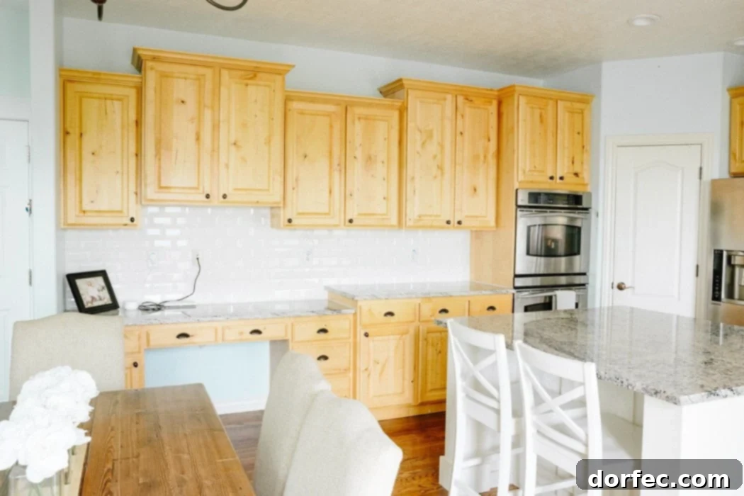 Before renovation kitchen showing existing dark cabinetry and a central island