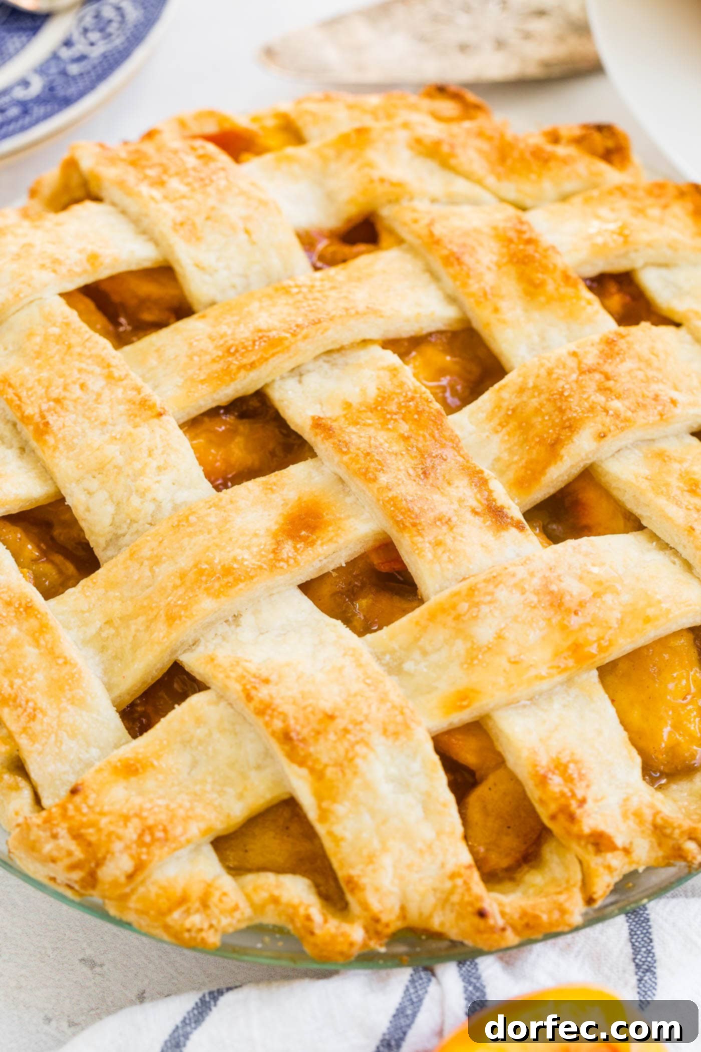 A photo of a fresh peach pie with lattice crust.