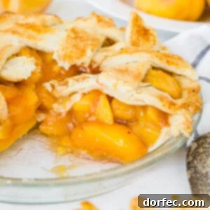 A photo of a fresh peach pie with a beautiful golden lattice crust.
