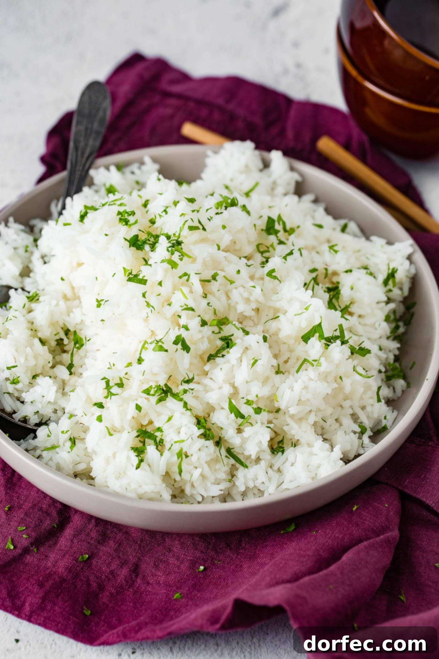 Fluffy White Rice Made Simple 5 a close-up of perfectly fluffed white rice with a fork