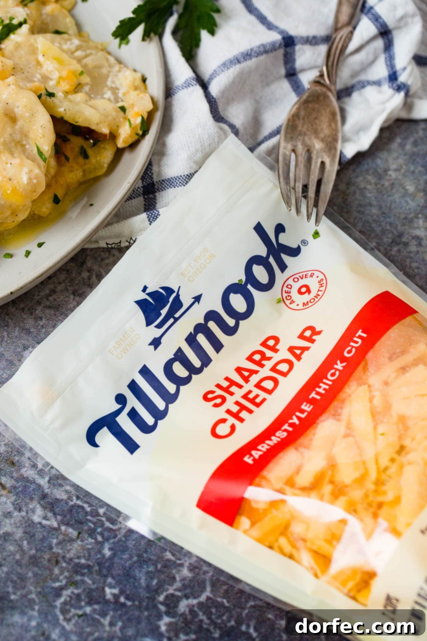 The Ultimate Cheesy Potato Casserole 6 More Tillamook Farmstyle Thick Cut Cheese Shreds, emphasizing the importance of quality cheese for the recipe.