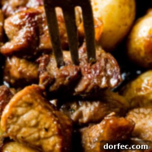 A close-up image of the finished Smoky Steak and Potatoes dish in a cast iron skillet.
