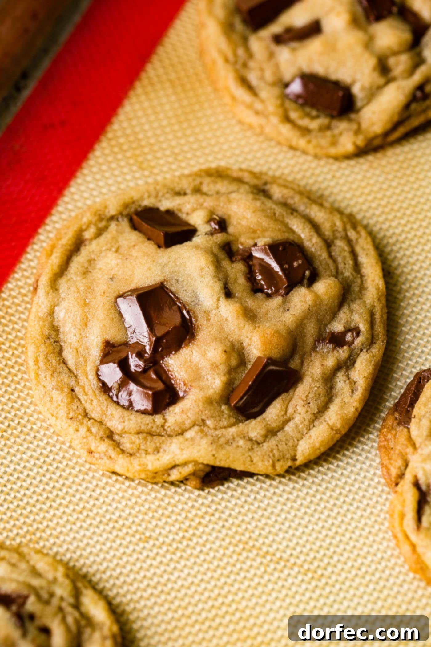 Ultimate Chocolate Chip Cookies 4 A stack of perfectly baked chocolate lover's cookies, featuring glistening melted chocolate and crunchy sea salt