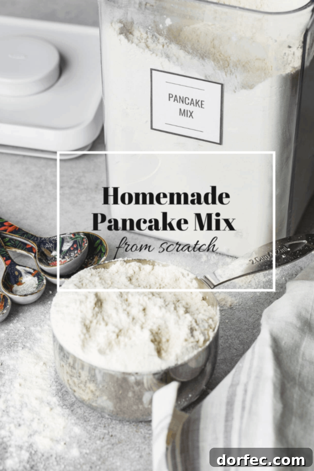 A measuring cup filled with flour sits next to metal measuring spoons. An open flour canister is visible in the background, reinforcing the theme of preparing homemade ingredients and pantry staples for easy cooking.
