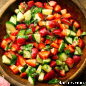 Honey Balsamic Strawberry Cucumber Salad 8 a photo of a wooden serving bowl full of strawberry cucumber salad