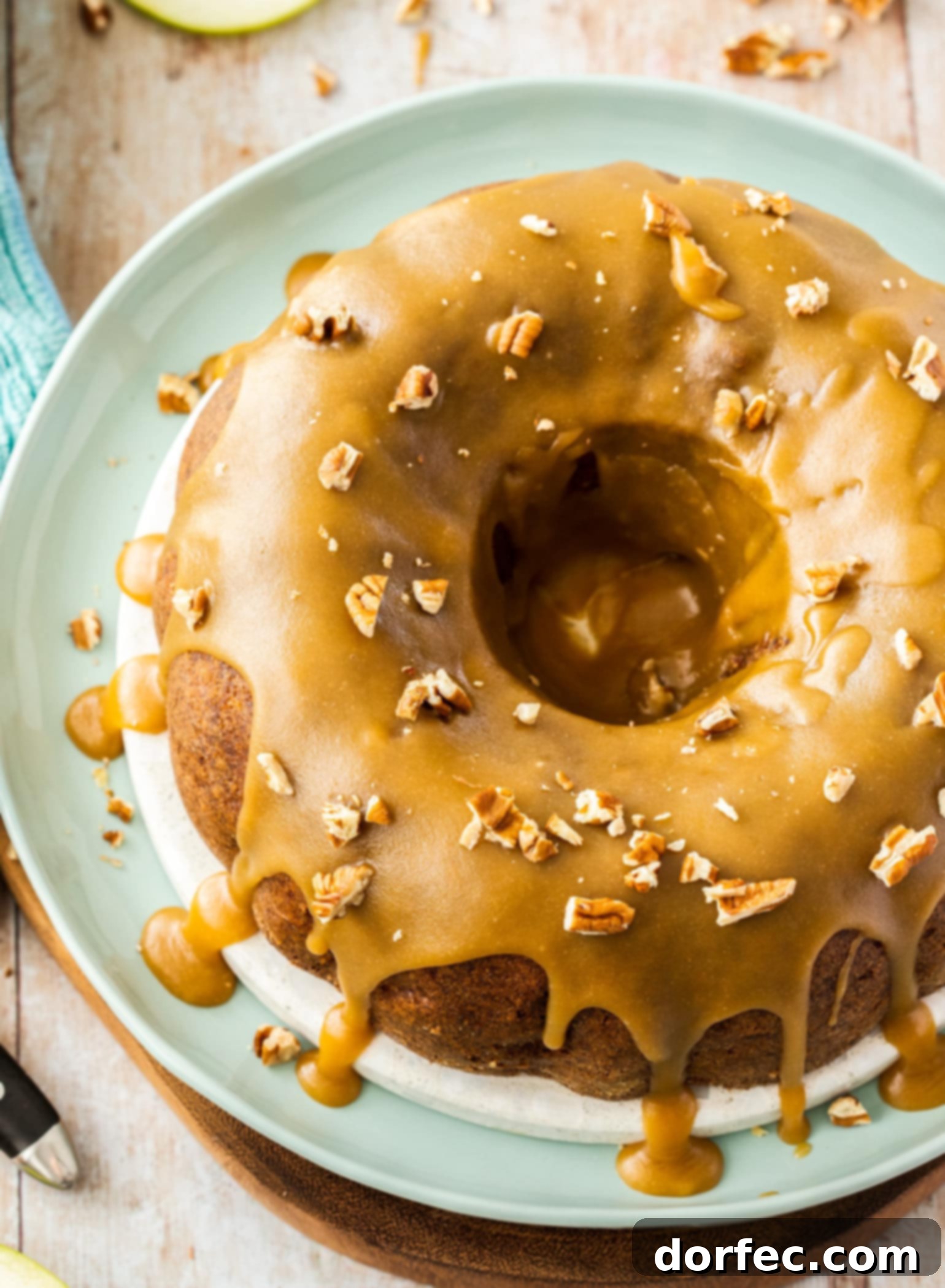A gorgeous bird's-eye view of a Pecan Apple Bundt Cake, generously drizzled with glistening caramel icing, inviting you to enjoy this fall delight.