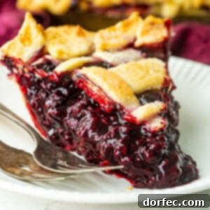 A vibrant Marionberry pie with a golden lattice crust, perfectly baked and ready to be served.