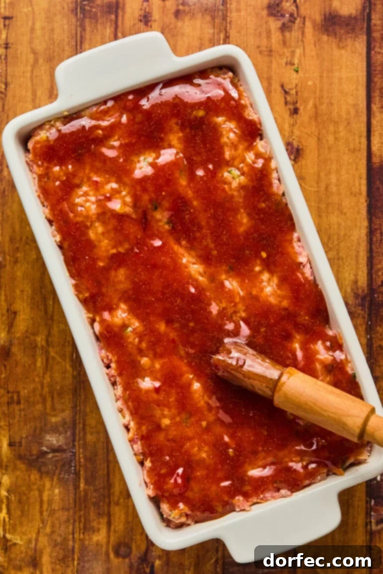Meatloaf baking in the oven, with the first layer of glaze set and slightly caramelized.