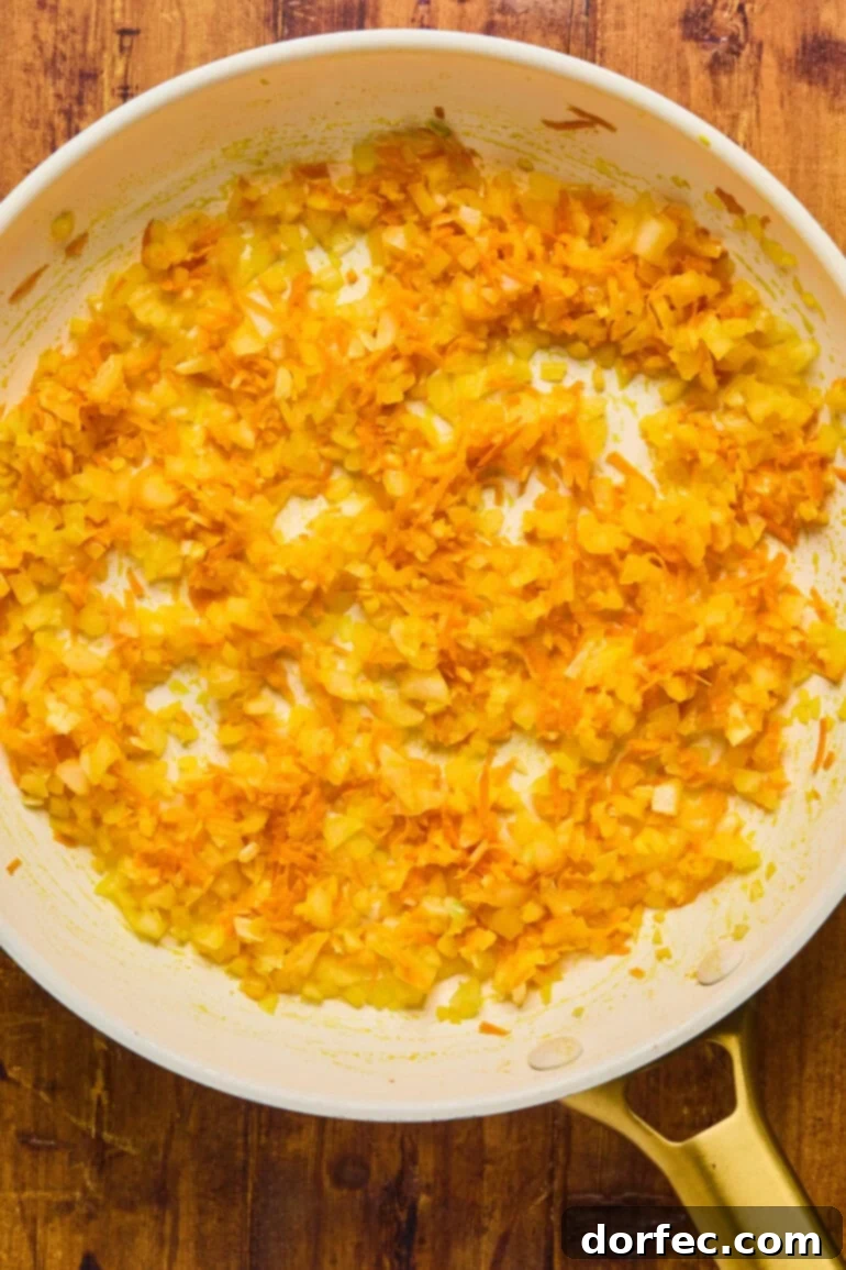 A small bowl containing whisked eggs, thyme, salt, pepper, and milk, forming the liquid binder for the meatloaf.