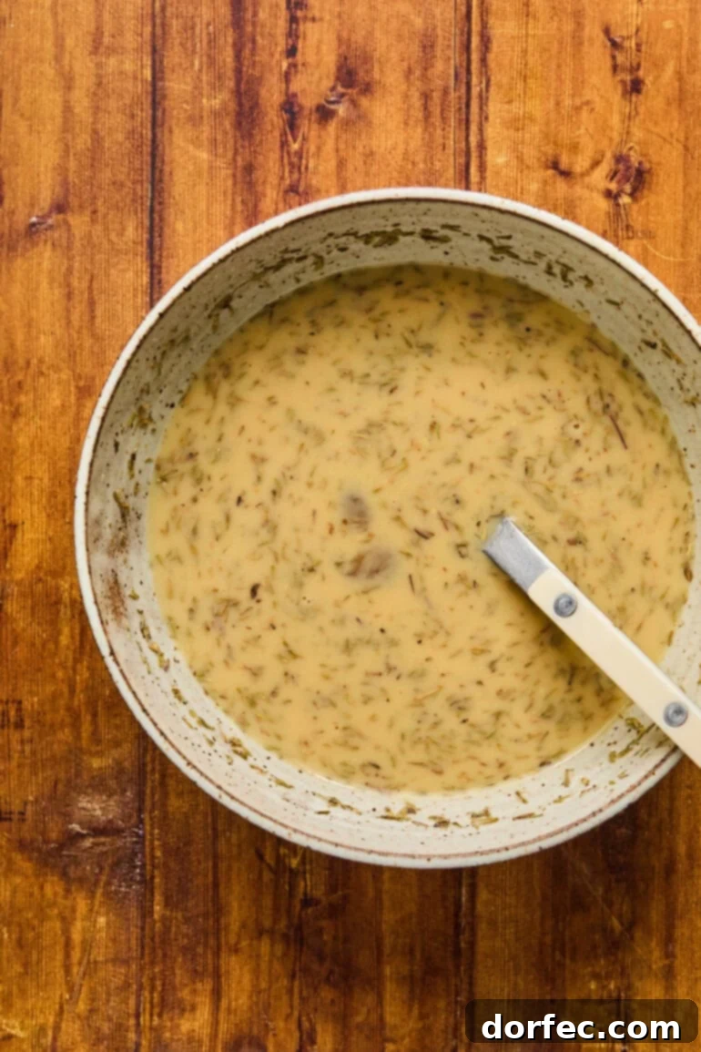 The ground meat blend (beef, pork, veal) in a large mixing bowl, awaiting the addition of wet ingredients and aromatics.