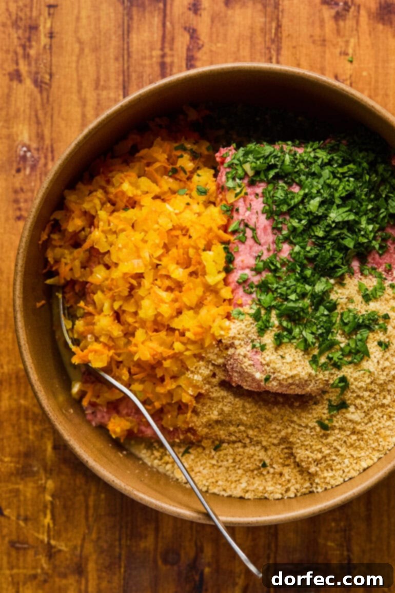 Mixed meatloaf ingredients in a bowl, showing the texture before forming into a loaf.