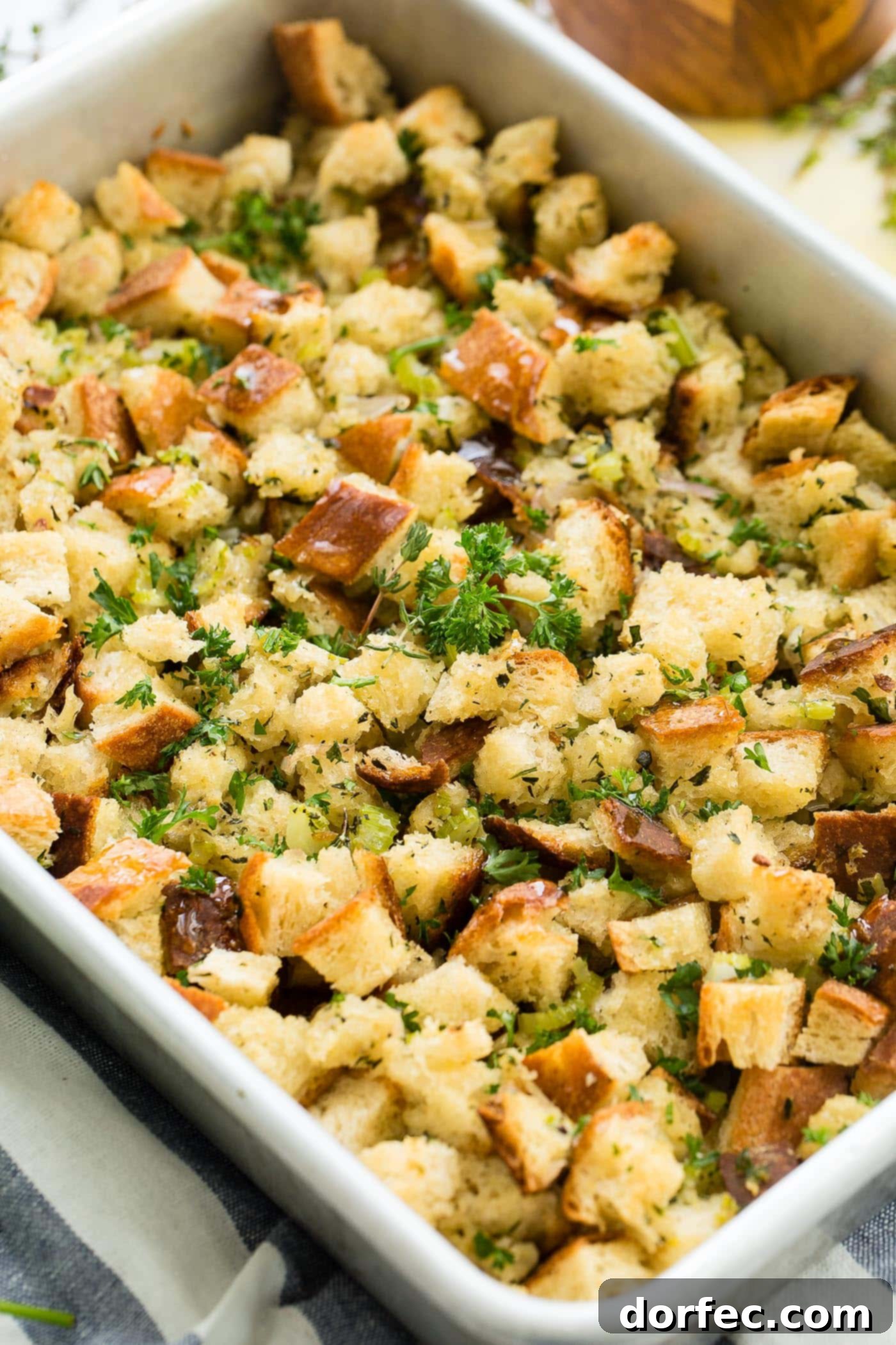 A photo of golden brown classic stuffing in a baking dish, ready to be served at a holiday meal.