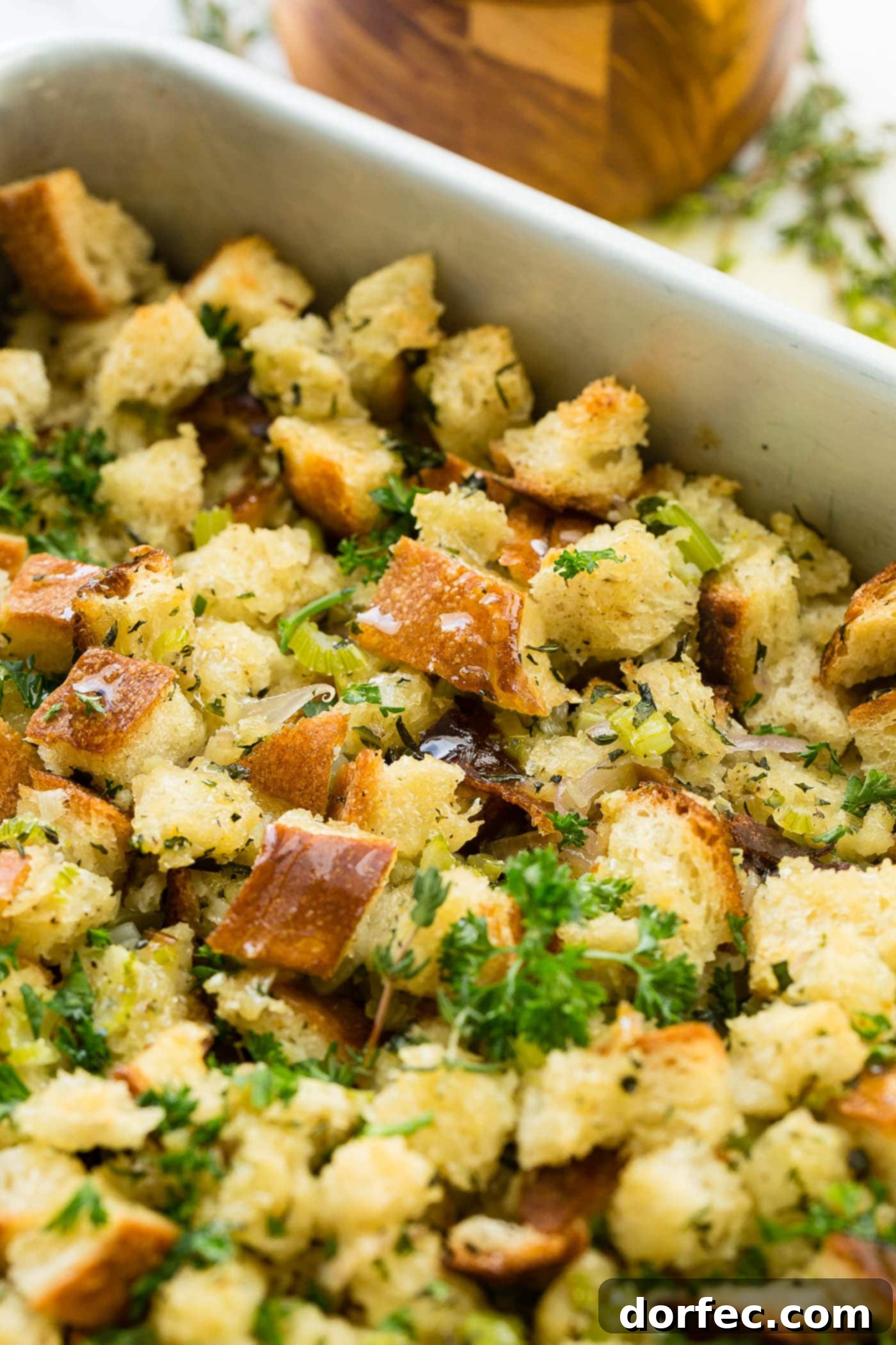 A photo of classic stuffing in a baking dish, perfectly baked with a golden crust.