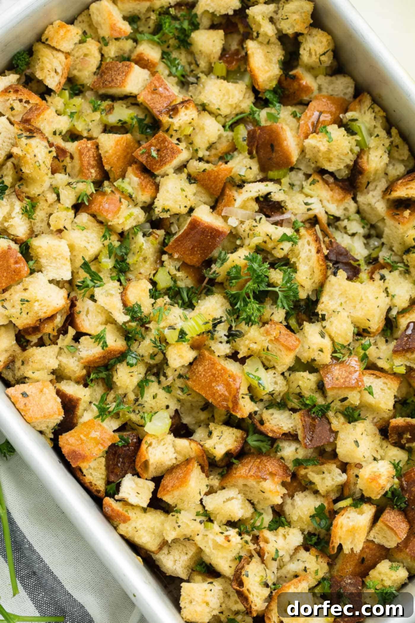 A photo of classic stuffing in a baking dish, showcasing its perfect golden crust.