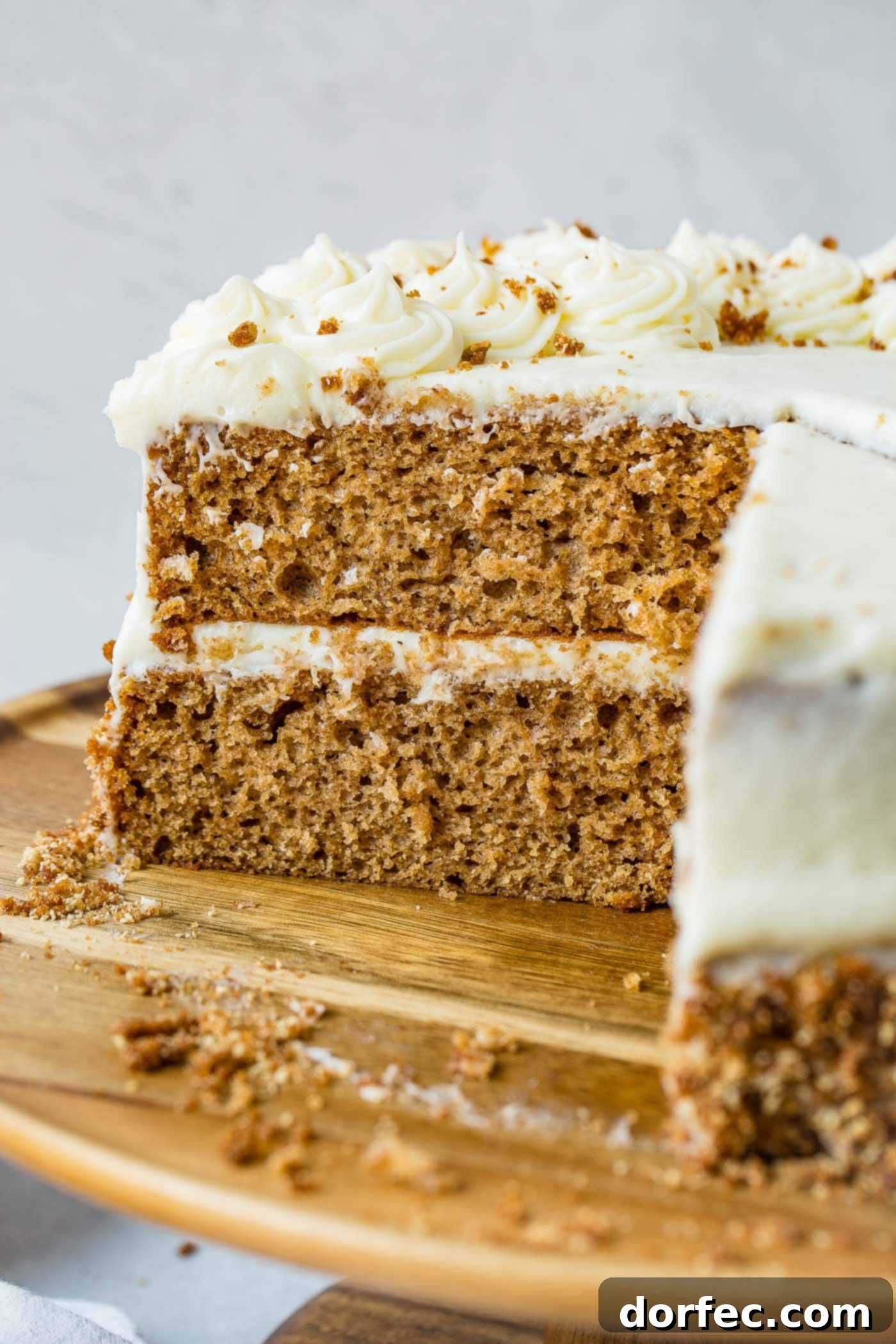 Classic Spice Cake with Cream Cheese Frosting A beautifully layered spice cake with luscious cream cheese frosting, a slice removed to show the moist interior.