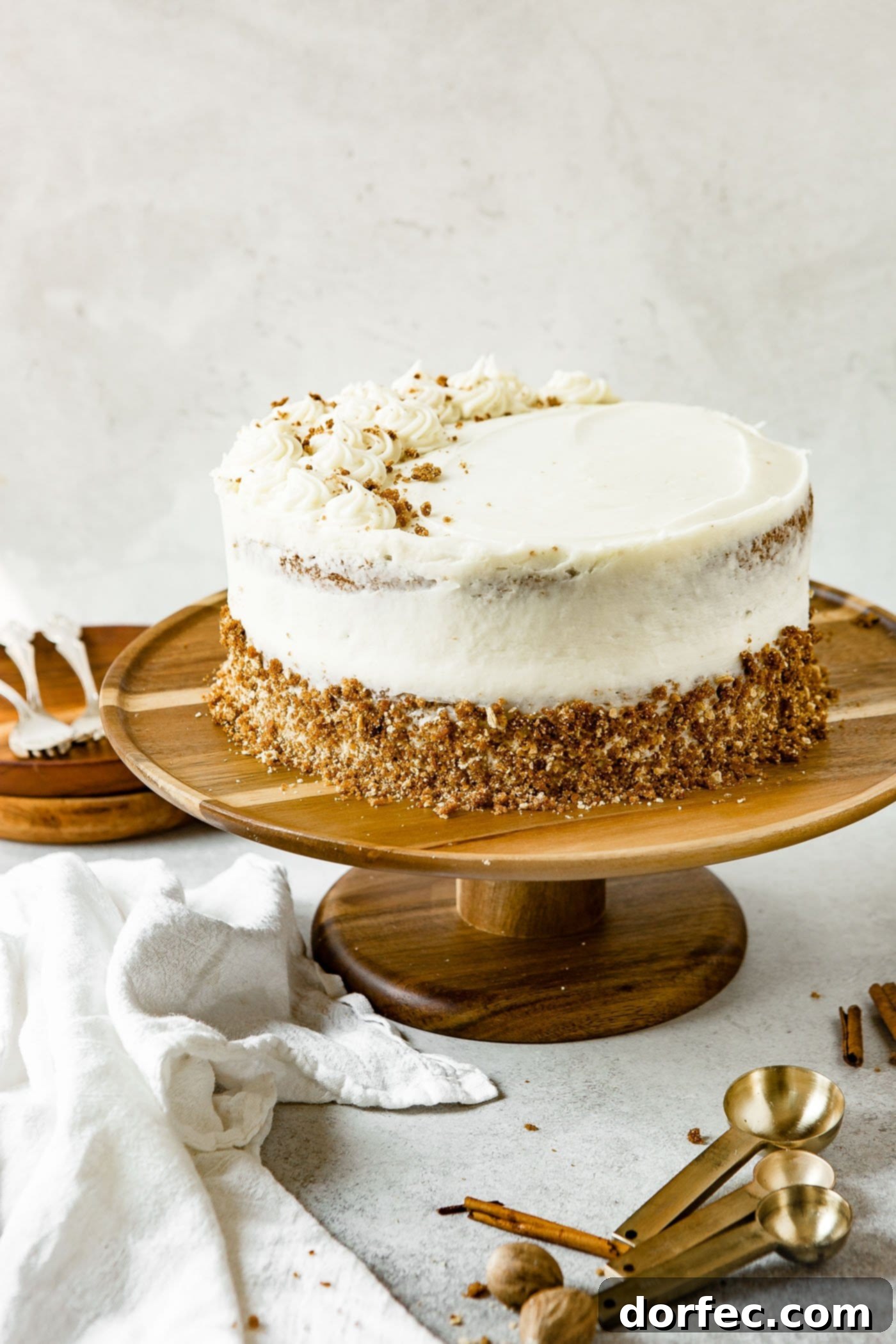 Rustic Spice Cake Decoration A two-layered spice cake, frosted with cream cheese frosting, with the bottom edge rolled in a crumb mixture for a rustic finish.